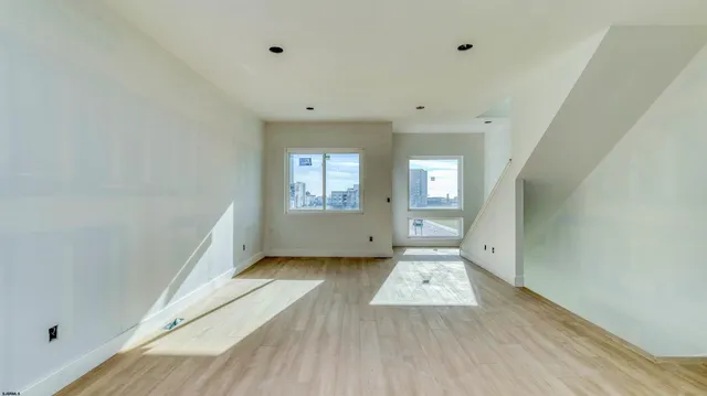 a view of wooden floor and windows in a room