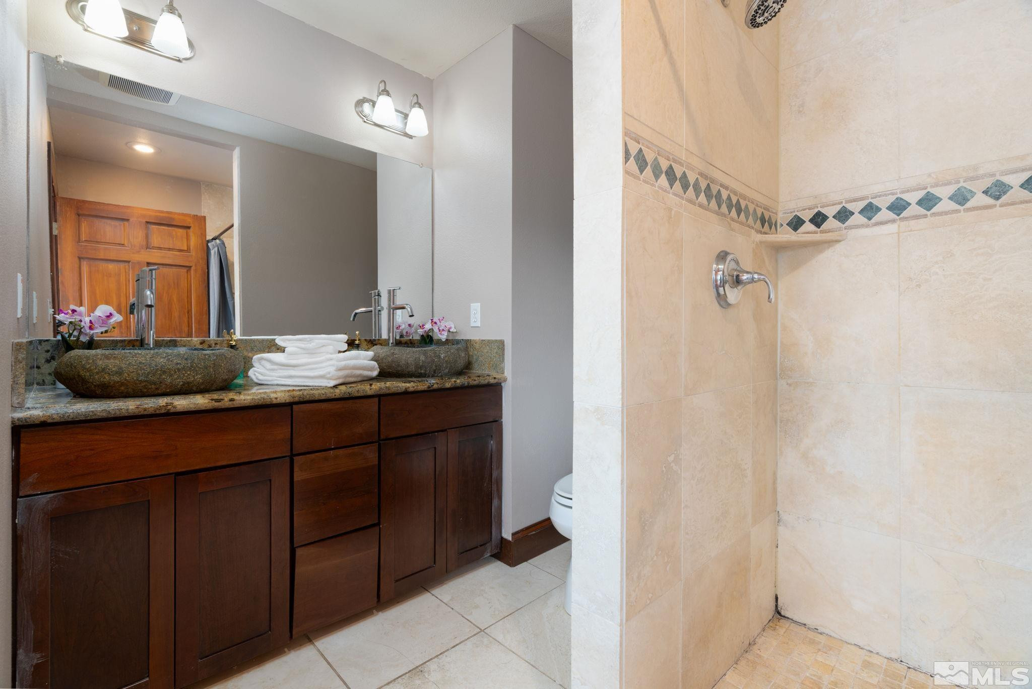 15350 Yankee Blade Road Reno, NV 89521 - Photo 11 of 27 a bathroom with a double vanity sink and a mirror