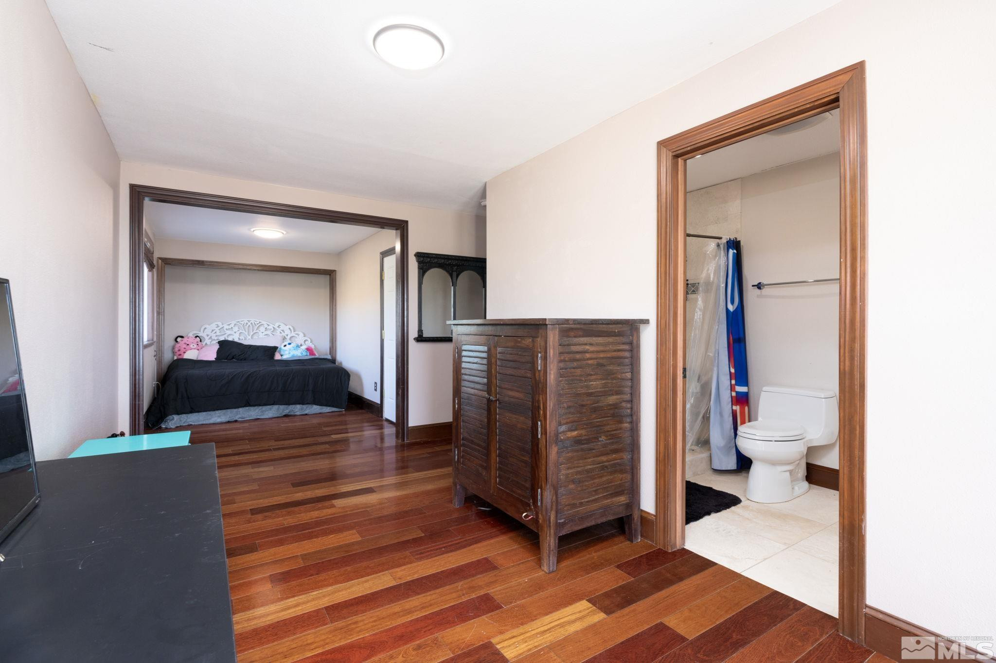 15350 Yankee Blade Road Reno, NV 89521 - Photo 12 of 27 a view of a hallway with wooden floor and furniture
