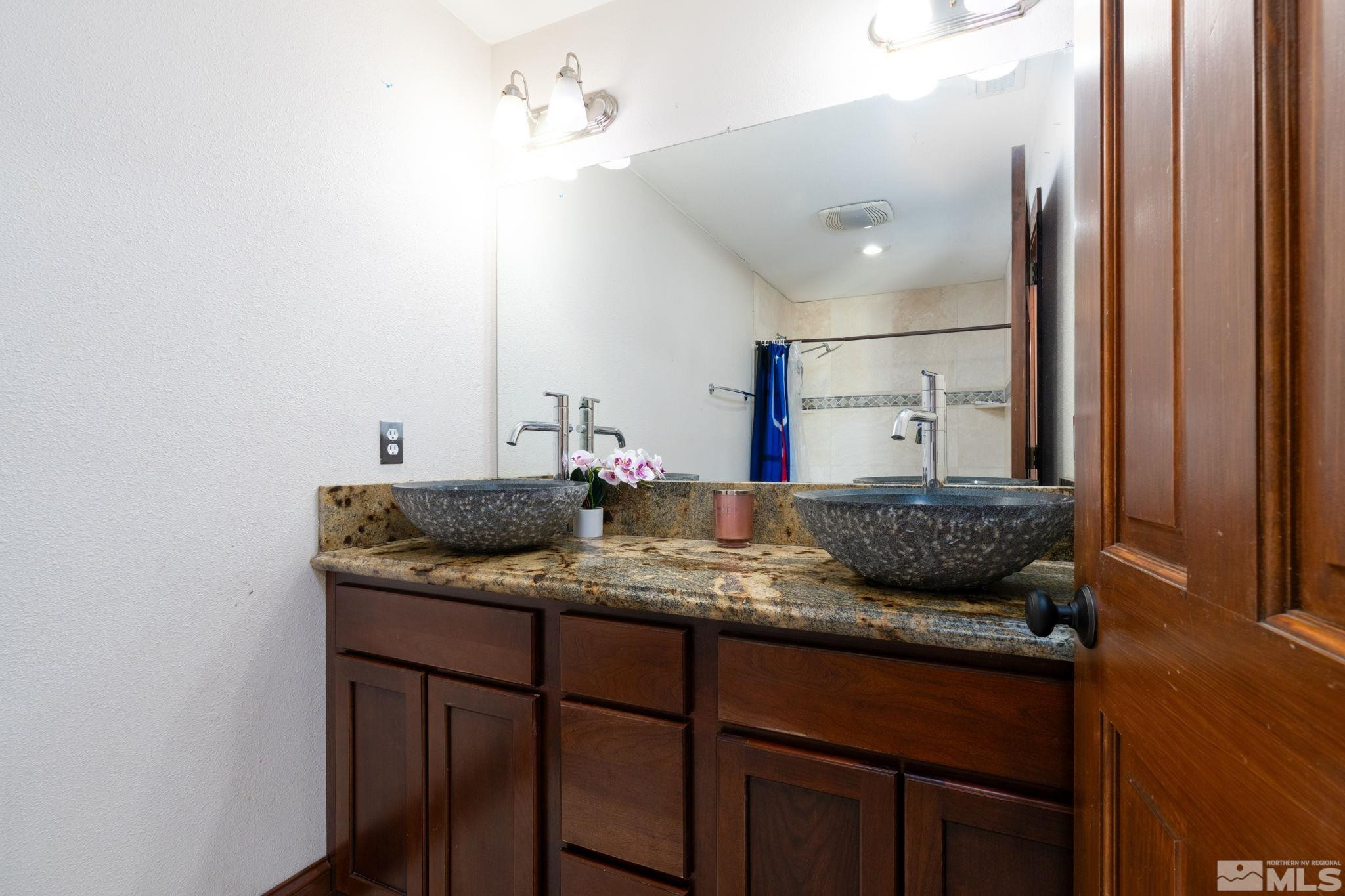 15350 Yankee Blade Road Reno, NV 89521 - Photo 13 of 27 a bathroom with a granite countertop sink and a mirror