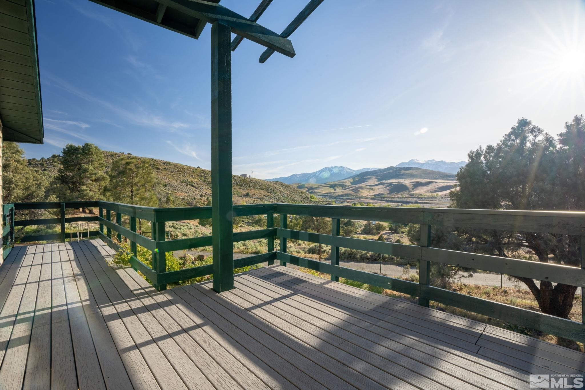 15350 Yankee Blade Road Reno, NV 89521 - Photo 19 of 27 a view of a balcony with wooden floor next to a yard