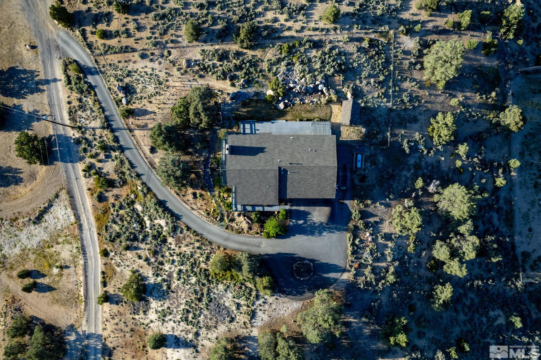 15350 Yankee Blade Road Reno, NV 89521 - Photo 2 of 27 an aerial view of a house with a yard and large trees