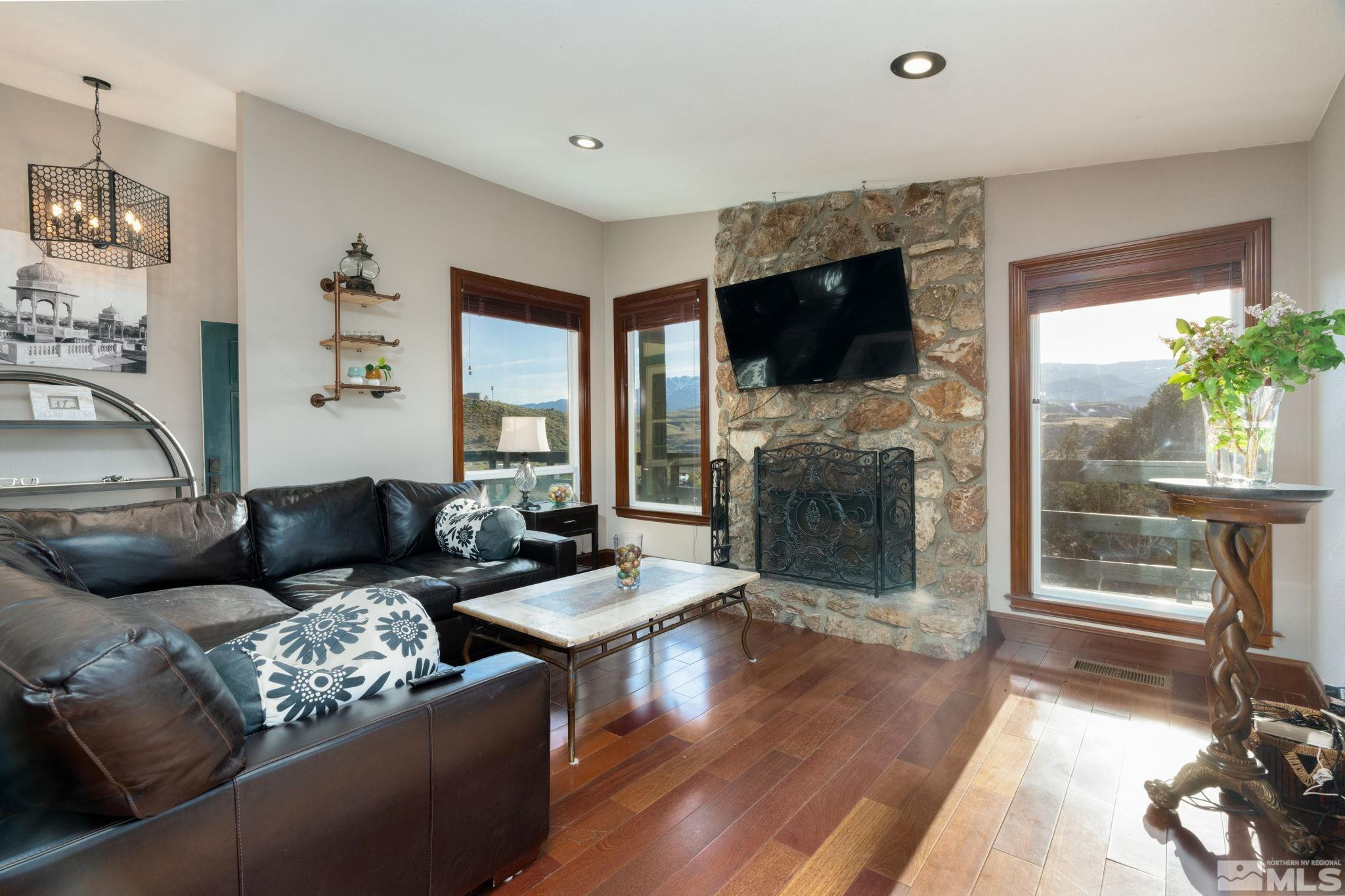 15350 Yankee Blade Road Reno, NV 89521 - Photo 5 of 27 a living room with furniture a flat screen tv and a fireplace