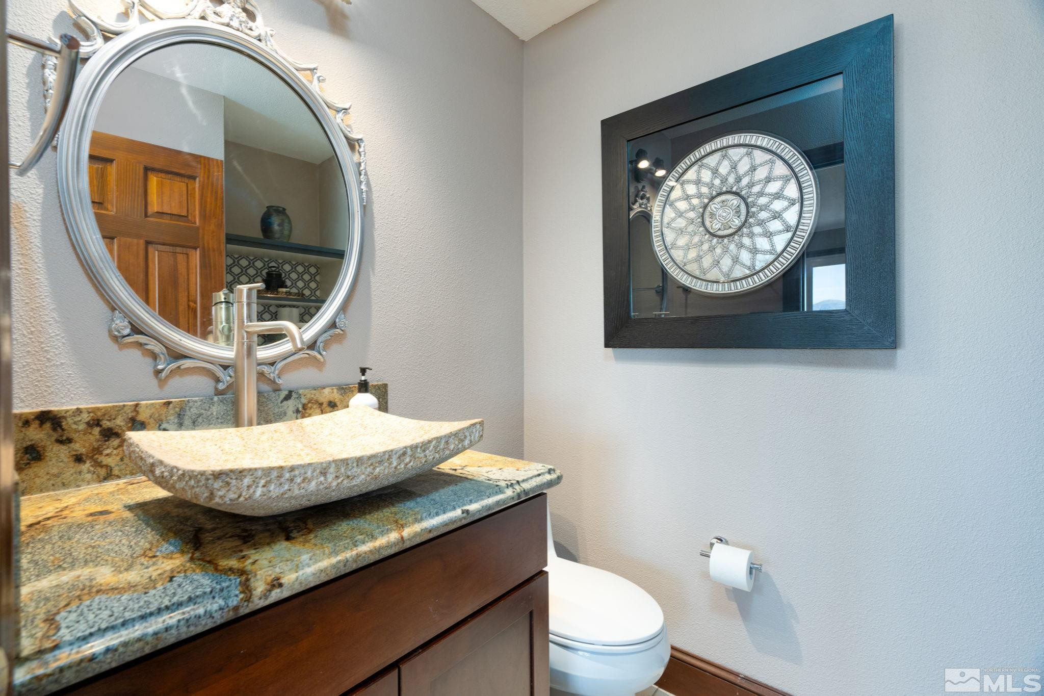 15350 Yankee Blade Road Reno, NV 89521 - Photo 6 of 27 a bathroom with a granite countertop toilet and a mirror