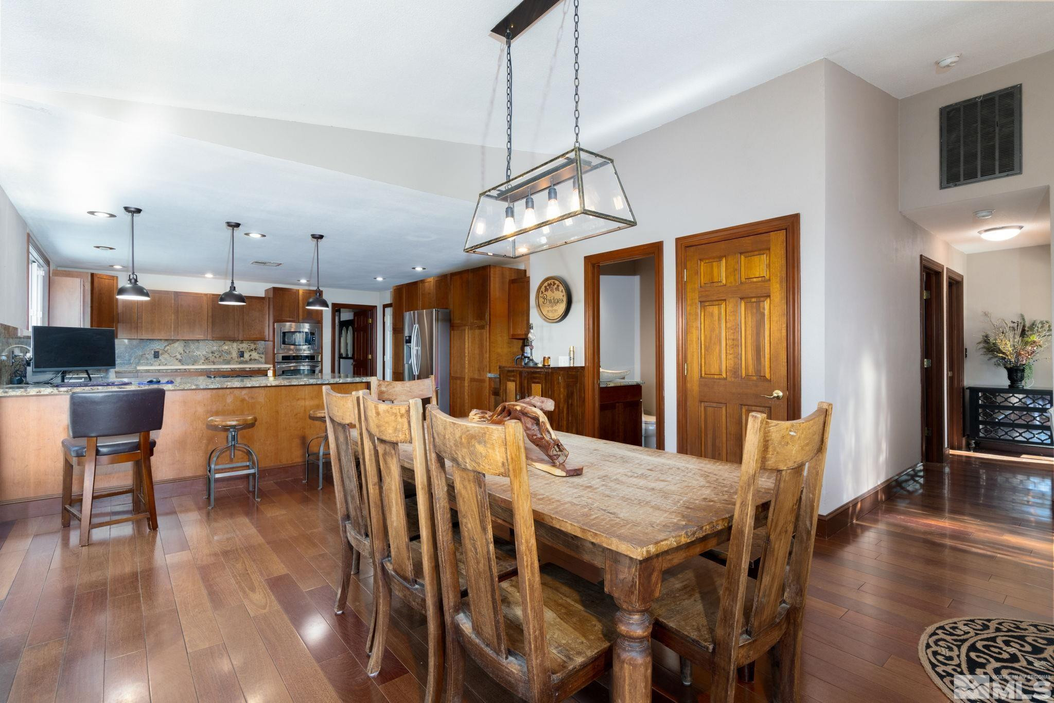 15350 Yankee Blade Road Reno, NV 89521 - Photo 7 of 27 a view of a dining room with furniture and wooden floor