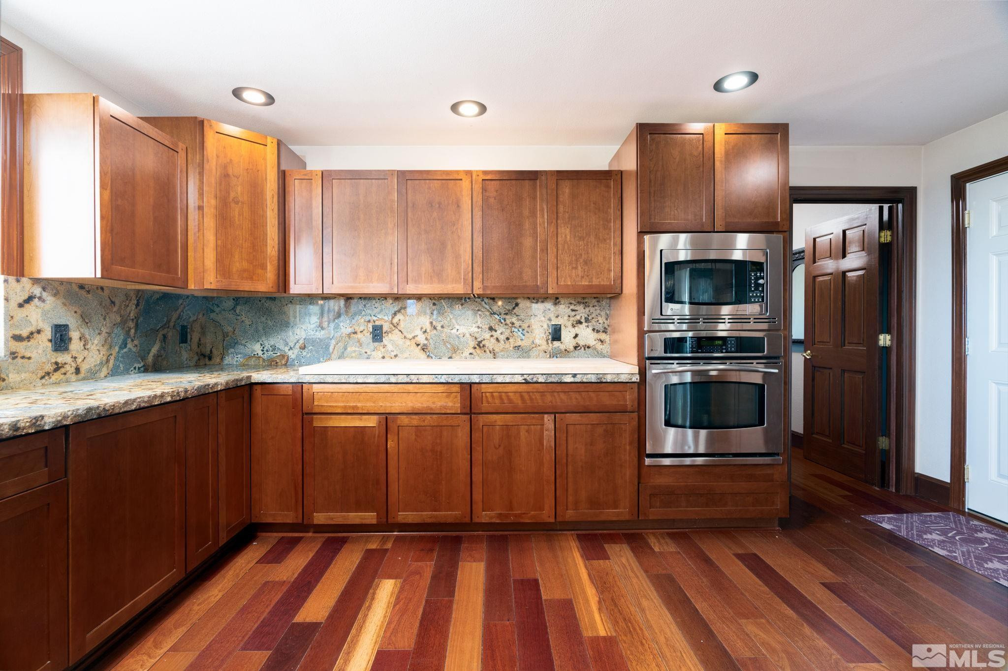 15350 Yankee Blade Road Reno, NV 89521 - Photo 8 of 27 a kitchen with granite countertop stainless steel appliances and wooden cabinets
