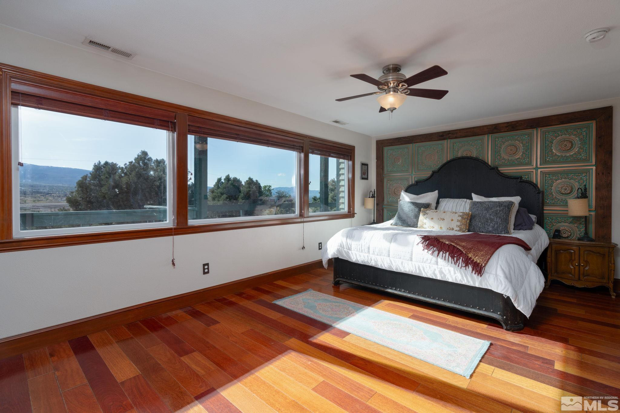 15350 Yankee Blade Road Reno, NV 89521 - Photo 9 of 27 a bedroom with a large bed and a large window