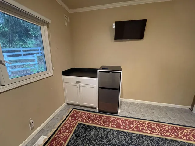 a view of storage and utility room with wooden floor