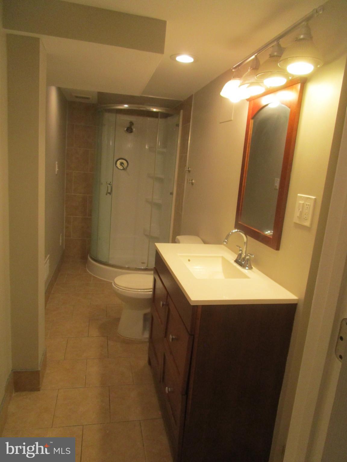 1908 Fenwood Avenue Oxon Hill, MD 20745 - Photo 14 of 15 a bathroom with a sink and mirror with toilet