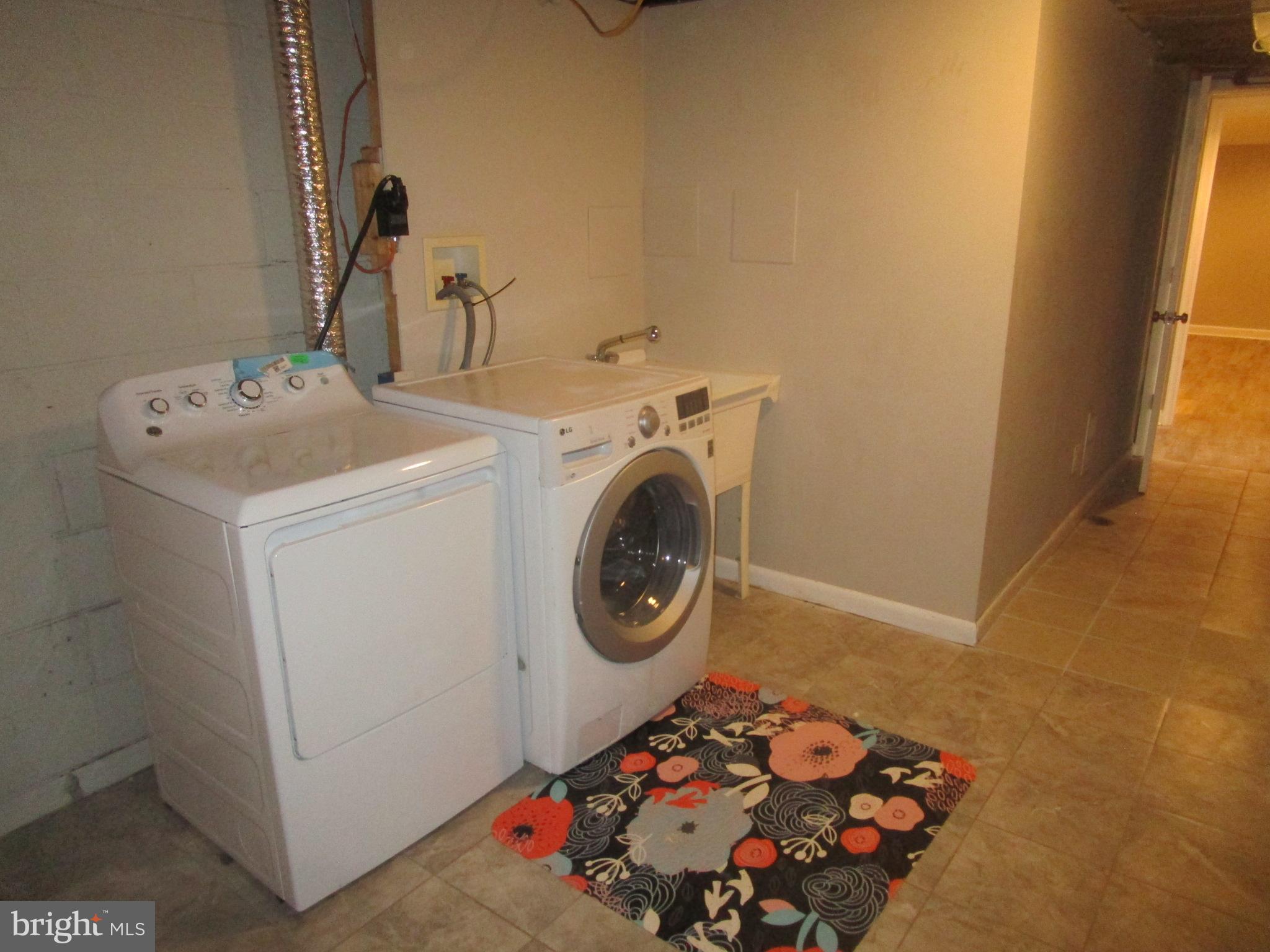 1908 Fenwood Avenue Oxon Hill, MD 20745 - Photo 15 of 15 a bathroom with a sink and a washer dryer