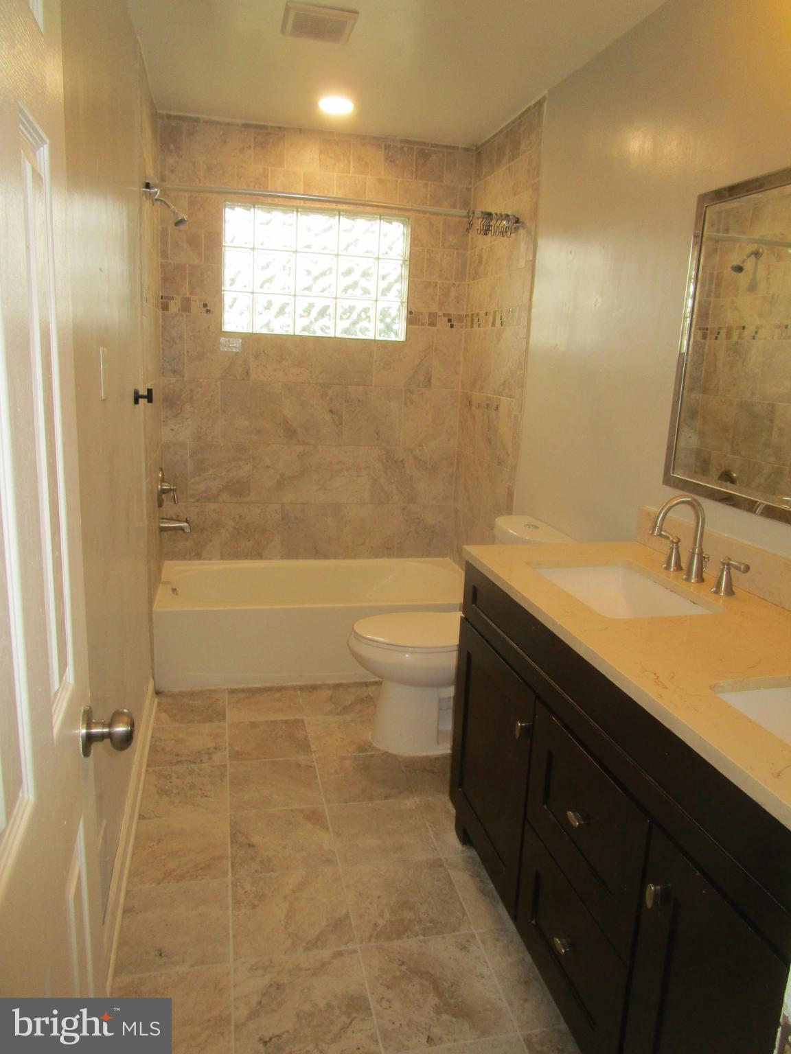 1908 Fenwood Avenue Oxon Hill, MD 20745 - Photo 7 of 15 a bathroom with a granite countertop sink toilet and shower