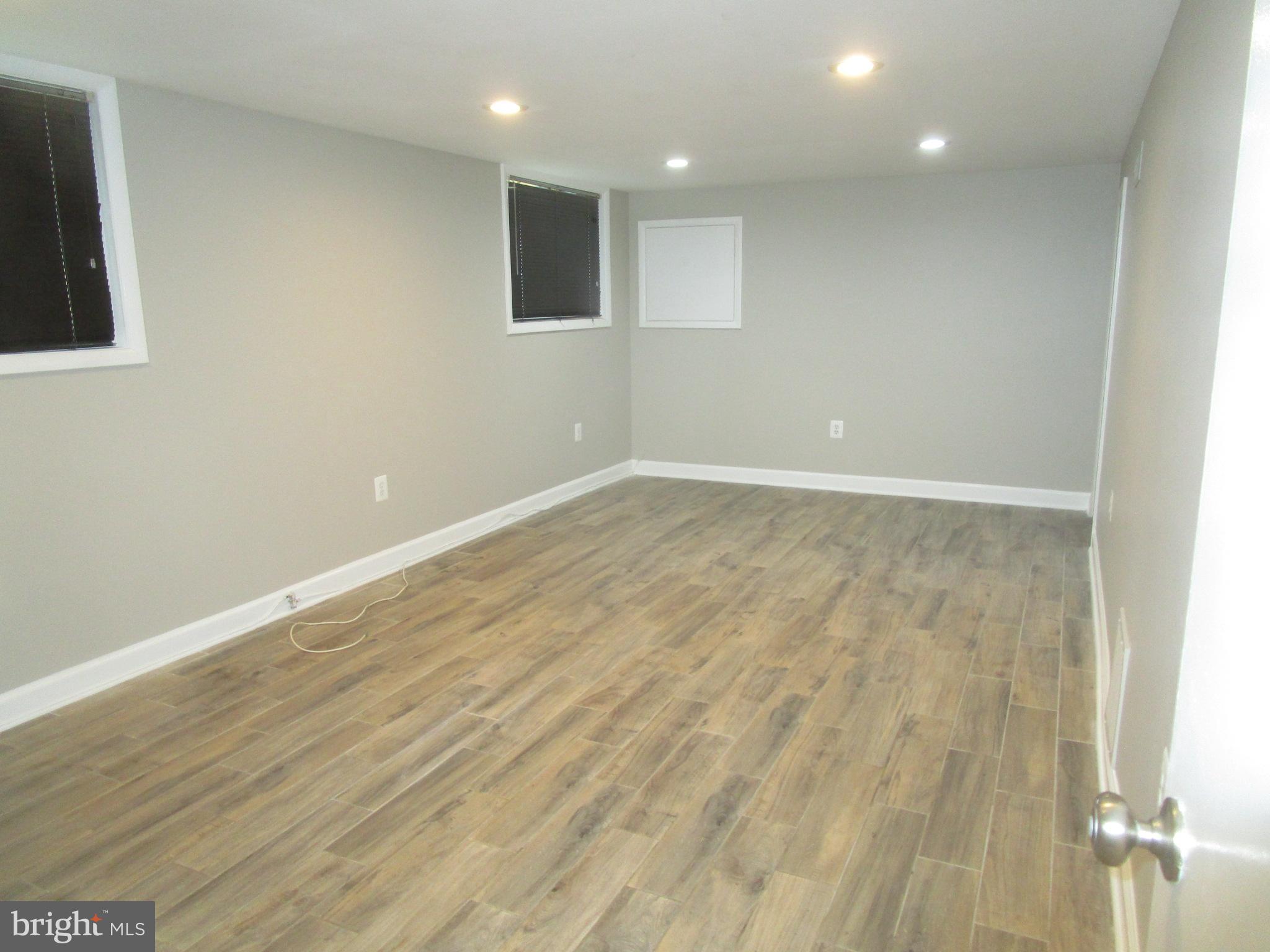 1908 Fenwood Avenue Oxon Hill, MD 20745 - Photo 8 of 15 an empty room with wooden floor and windows