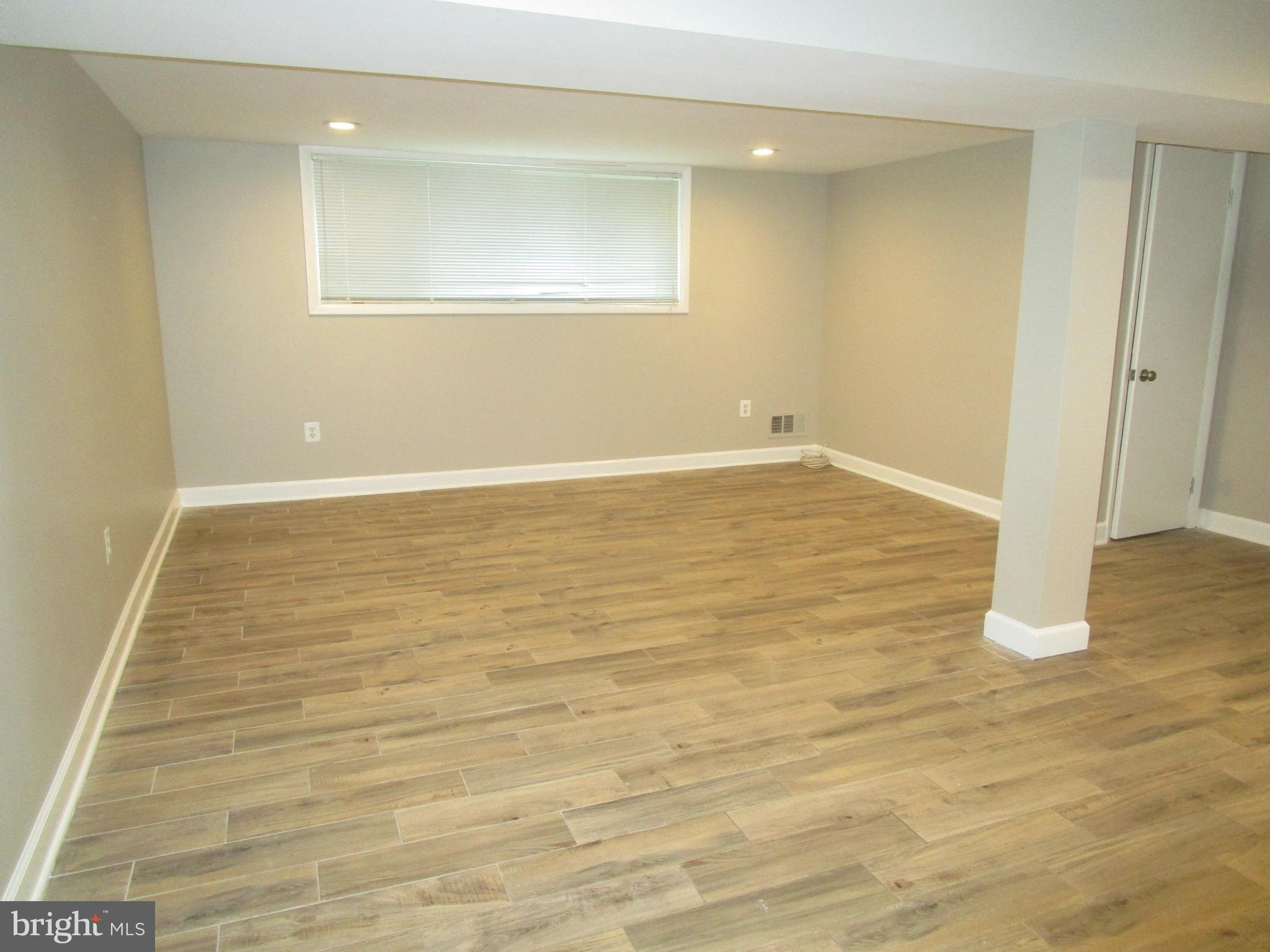 1908 Fenwood Avenue Oxon Hill, MD 20745 - Photo 9 of 15 a view of an empty room with wooden floor and a window