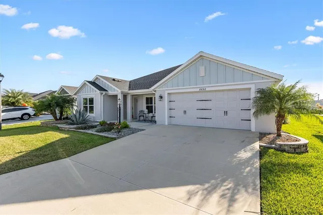 a view of a house with a yard and garage