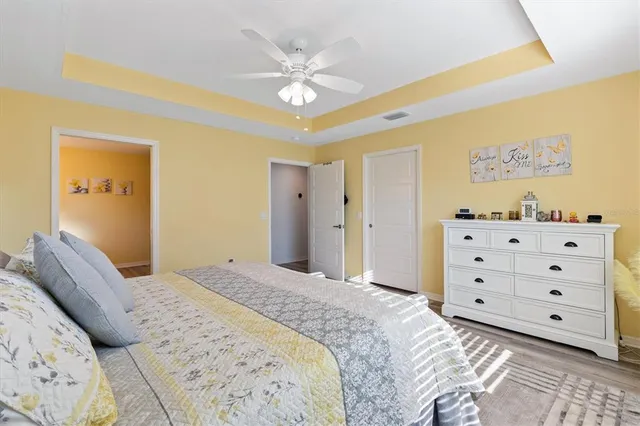 a spacious bedroom with a bed and a cabinets