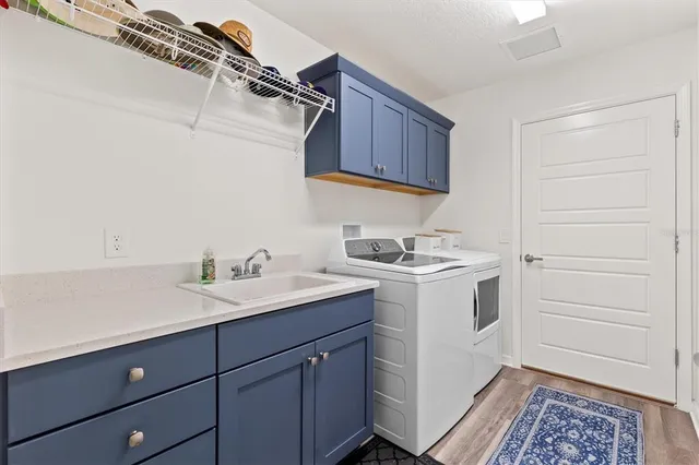 a utility room with sink dryer and washer
