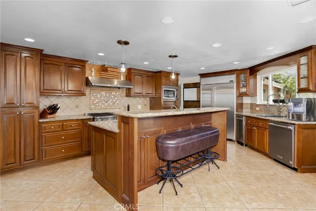 a kitchen with stainless steel appliances granite countertop a stove and a sink