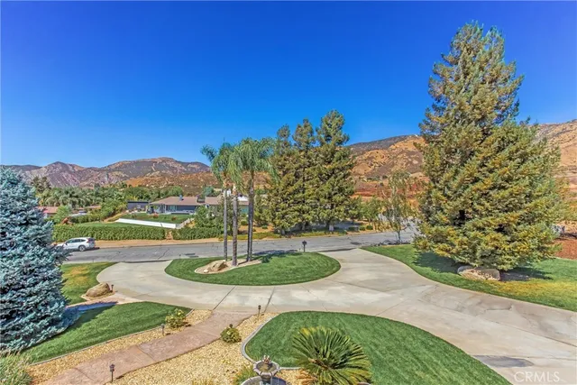 a view of a house with pool and chairs