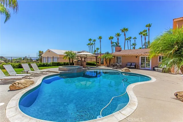 a view of a swimming pool with a table and chairs