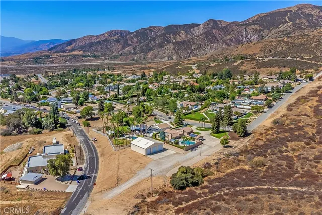 a front view of a house with a yard and potted plants