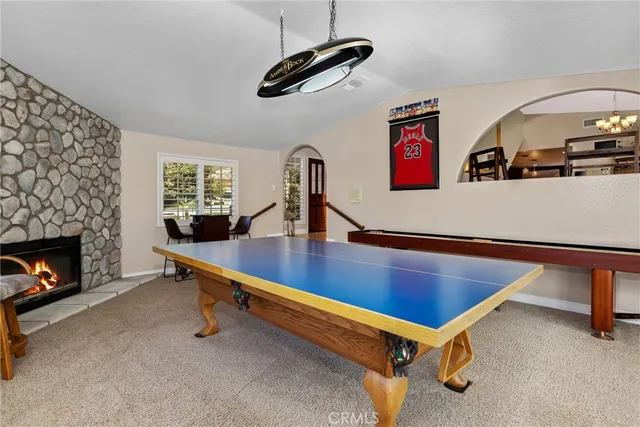 a view of a dining room with furniture and chandelier