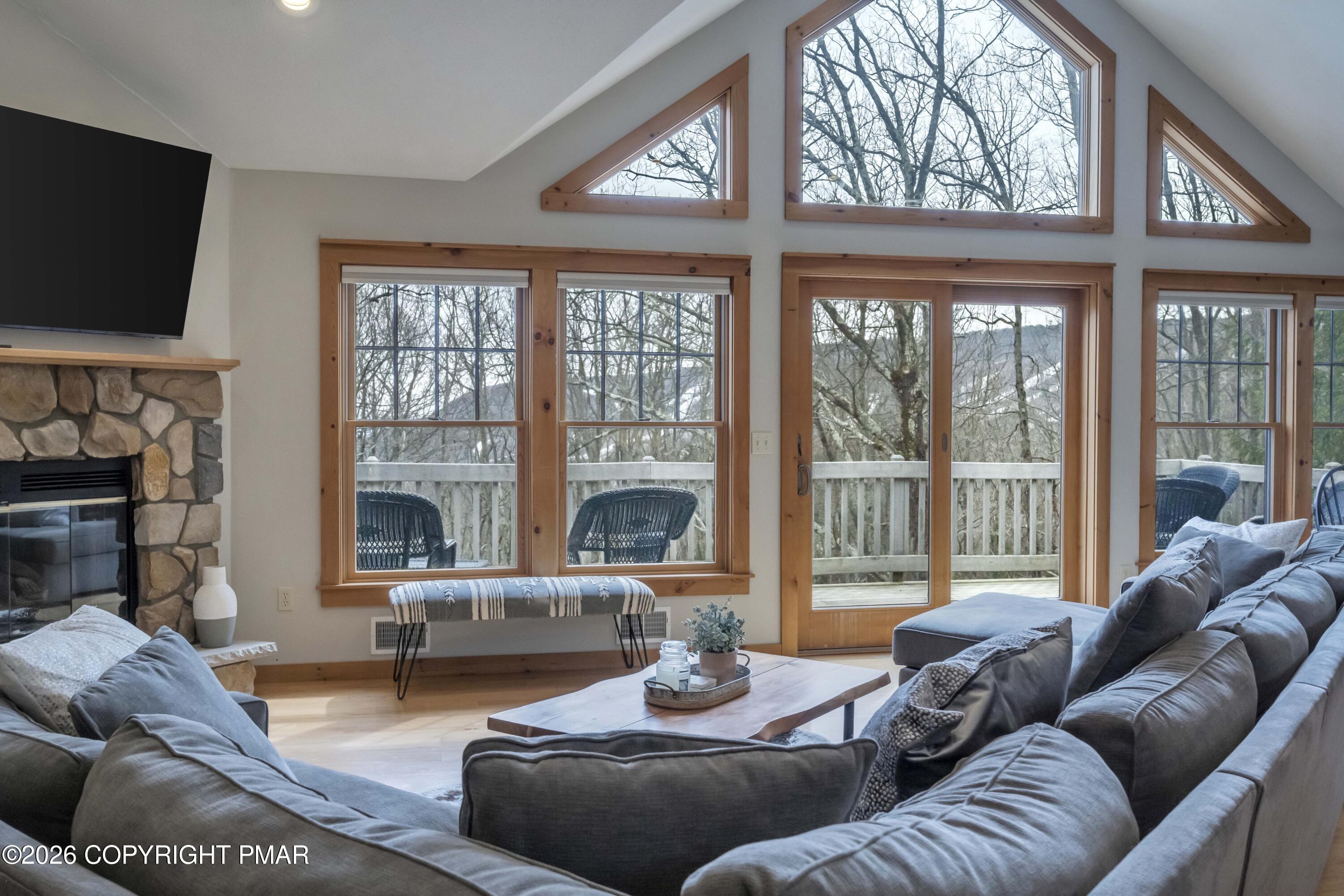 188 Upper Deer Valley Road Tannersville, PA 18372 - Photo 12 of 49 a living room with furniture a flat screen tv and a large window
