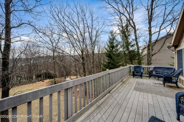 a balcony with wooden floor and wooden fence
