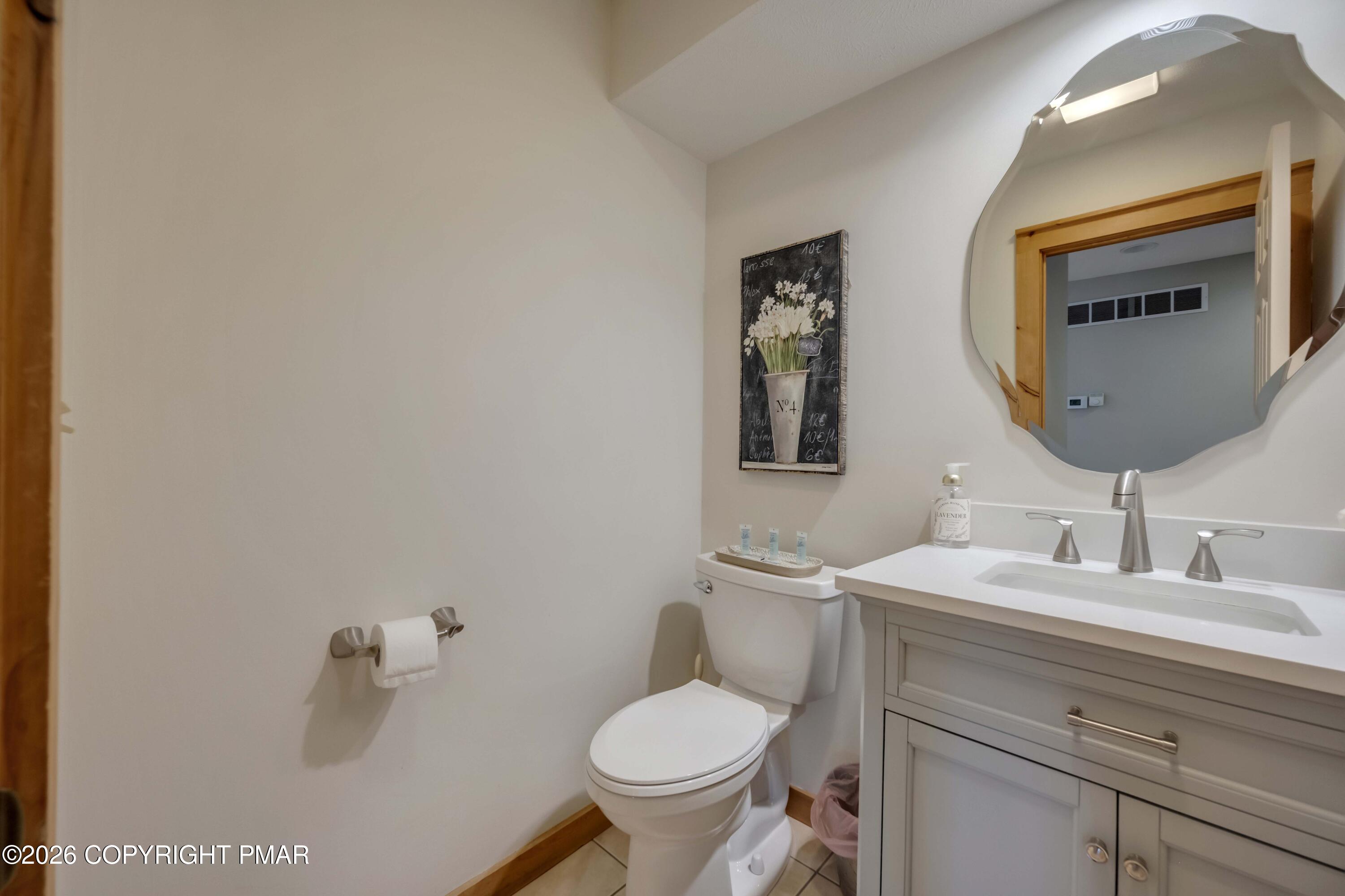 188 Upper Deer Valley Road Tannersville, PA 18372 - Photo 18 of 49 a bathroom with a toilet sink and mirror