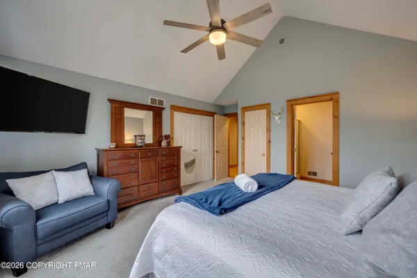 a bedroom with a large bed and a couch