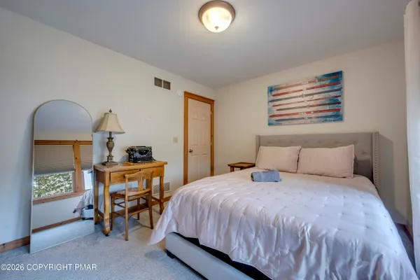 a bedroom with a bed a table and chair