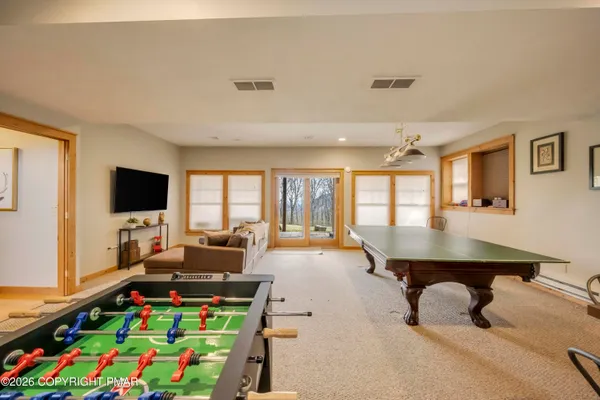 a room with furniture and large flat screen tv