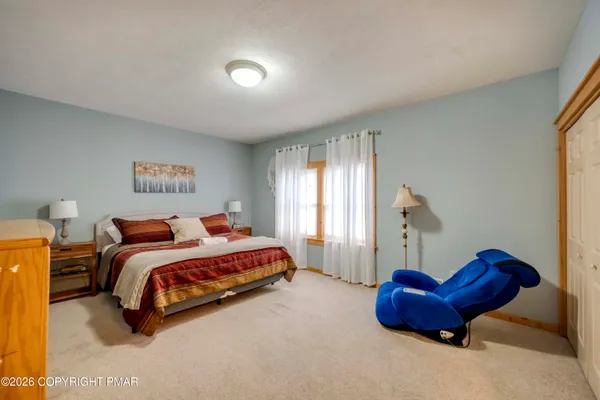 a bedroom with a bed and a couch