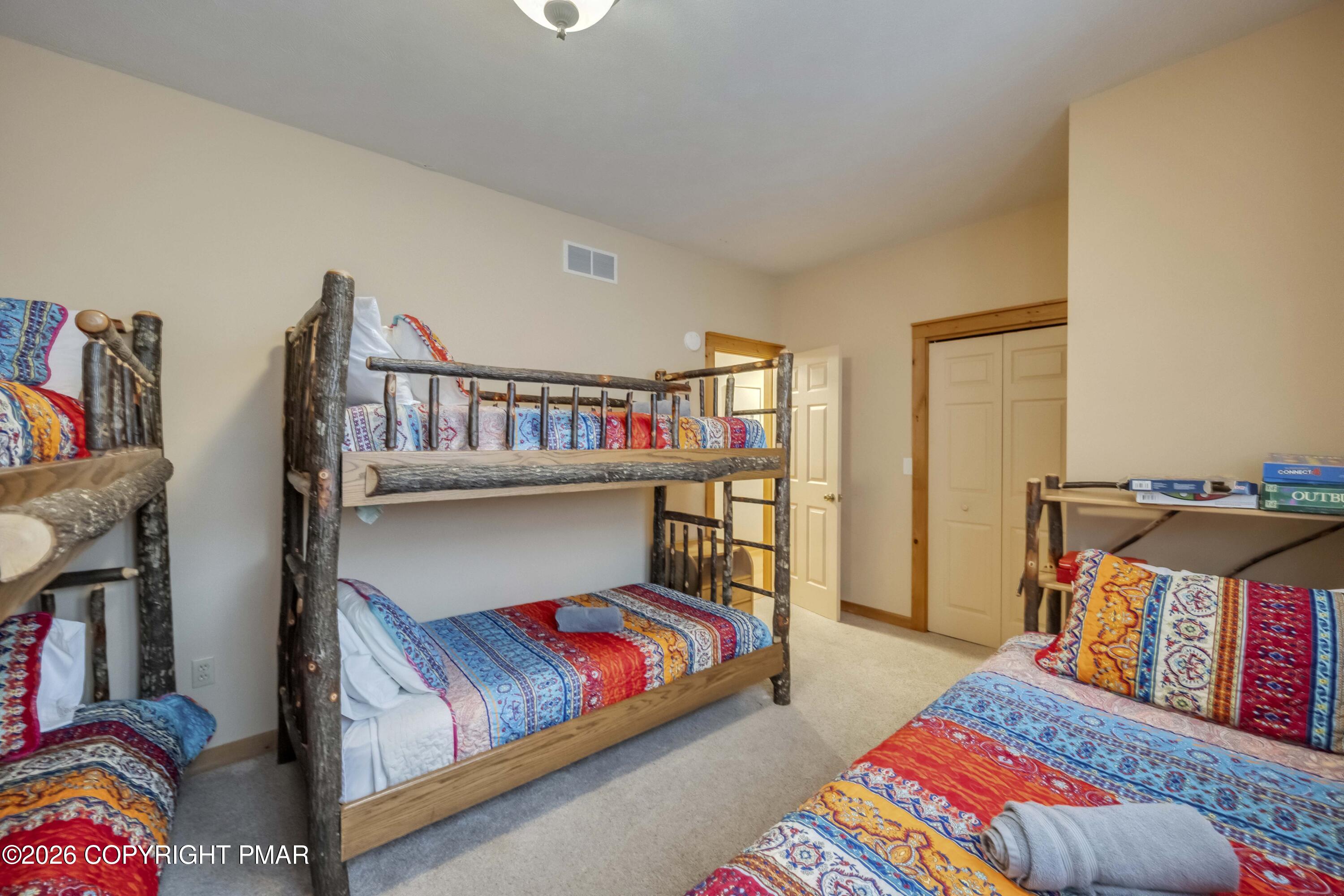 188 Upper Deer Valley Road Tannersville, PA 18372 - Photo 37 of 49 a bedroom with furniture and a book shelf