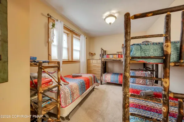 a bedroom with bed and a window