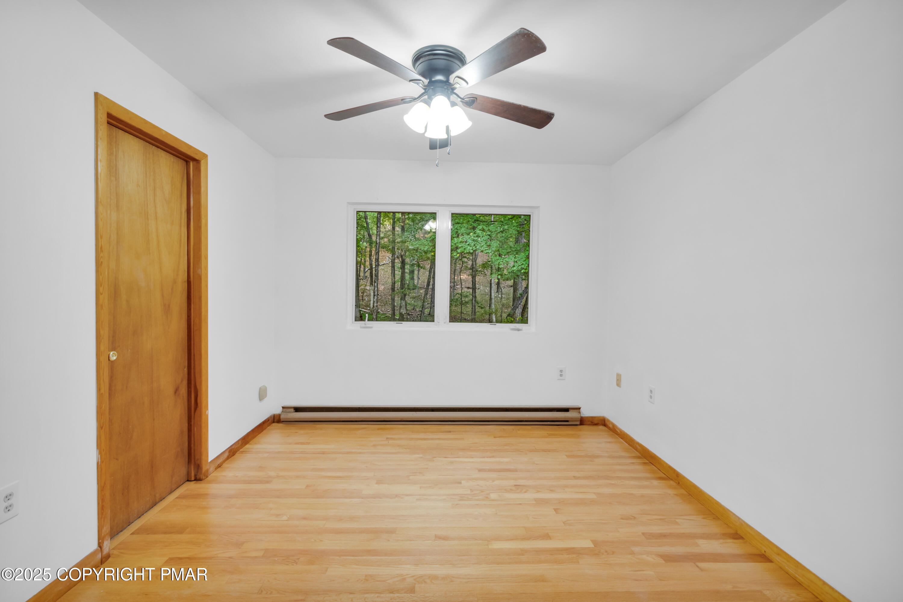 326 Otter Court Bushkill, PA 18324 - Photo 19 of 47 an empty room with windows and ceiling fan