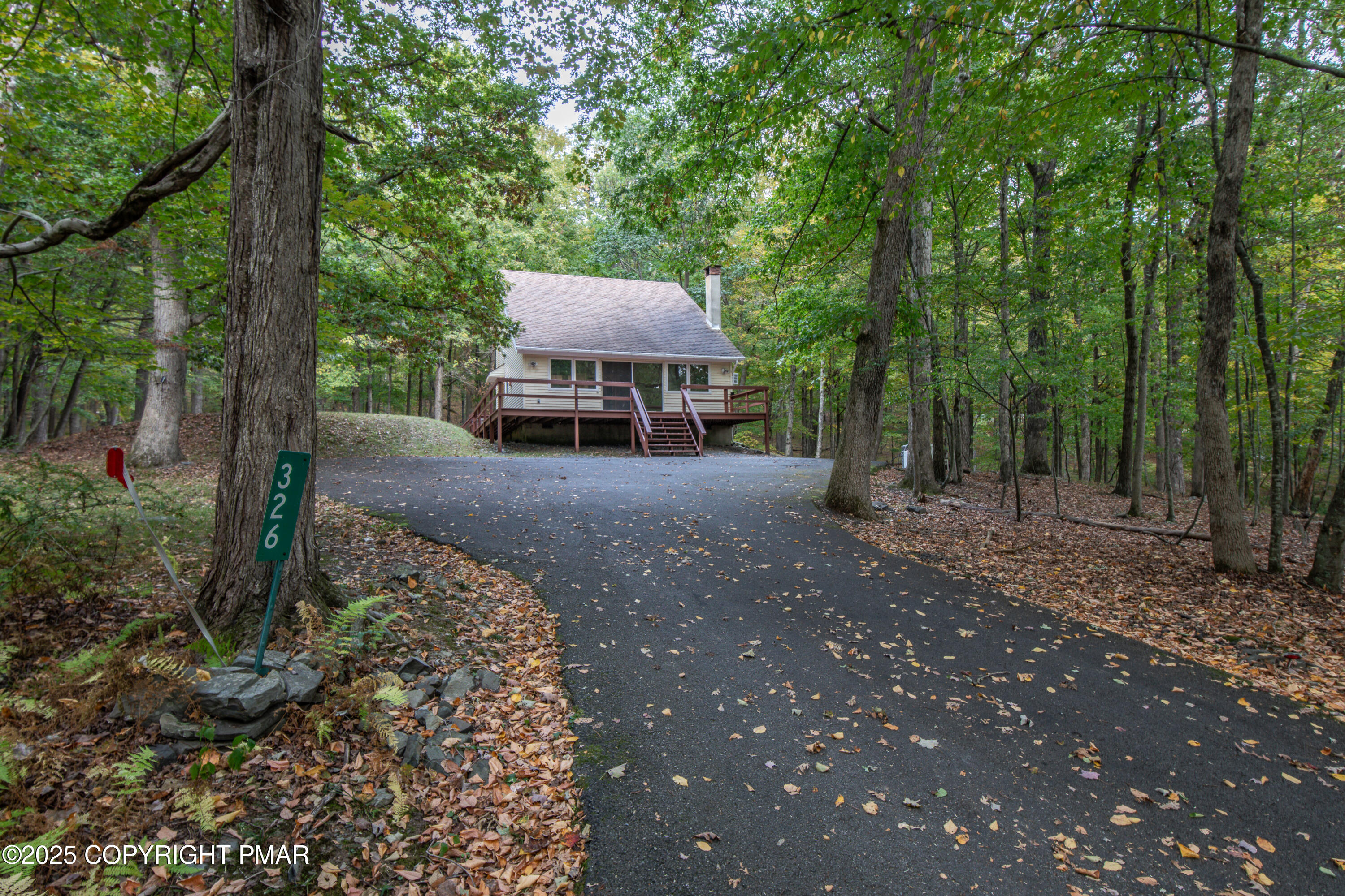 326 Otter Court Bushkill, PA 18324 - Photo 43 of 47 a view of a backyard with large trees and plants