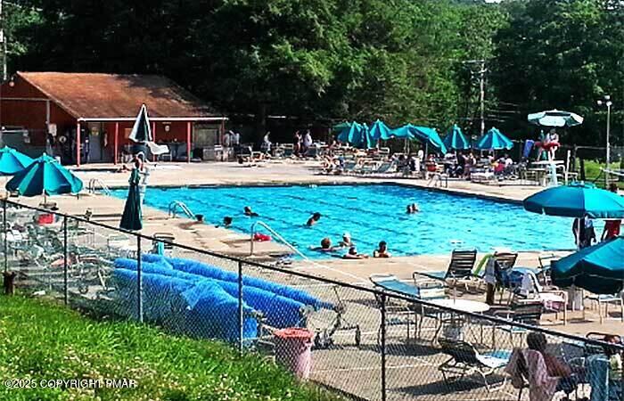 326 Otter Court Bushkill, PA 18324 - Photo 44 of 47 a view of a patio with table and chairs potted plants and palm trees