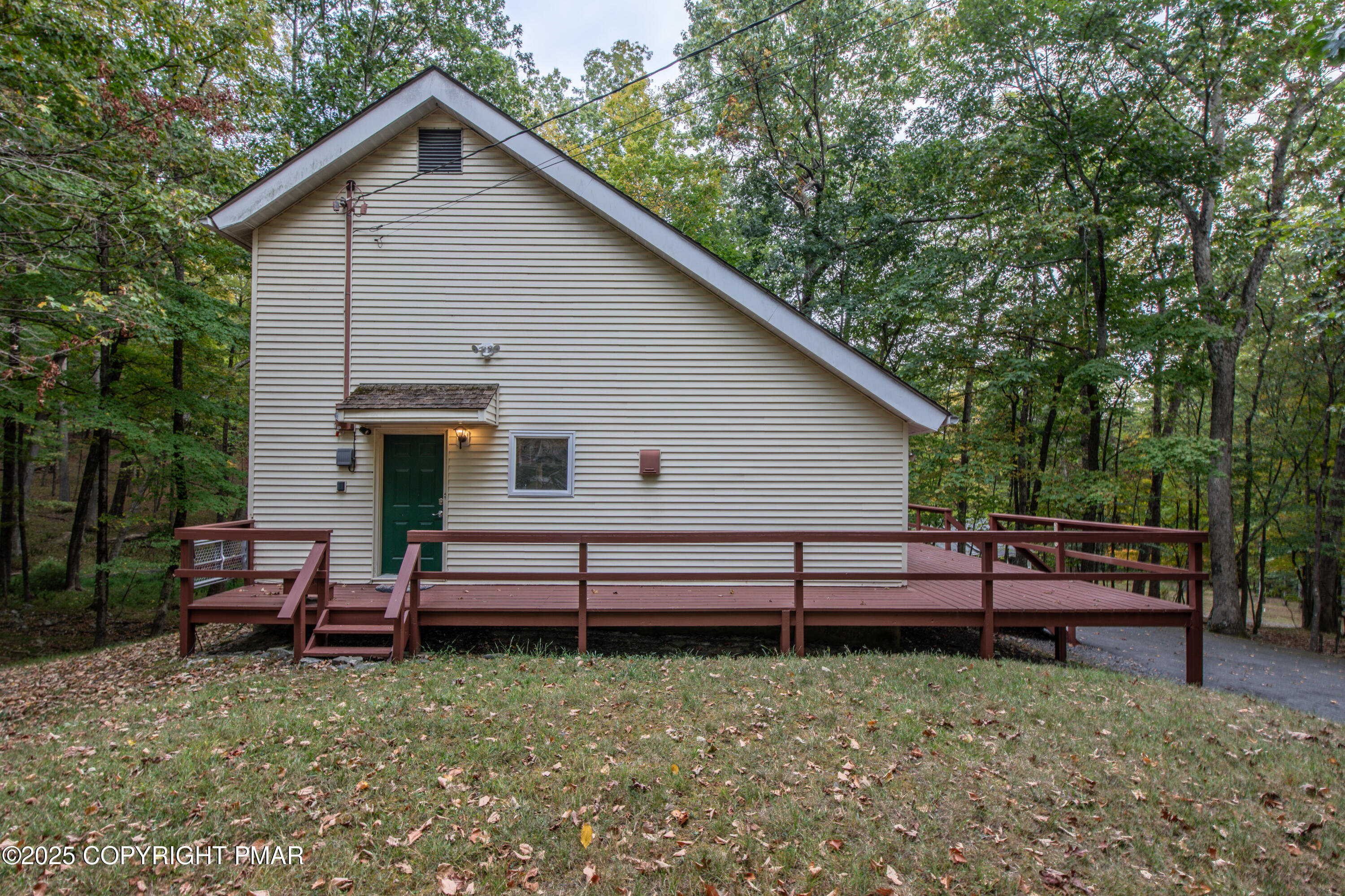 326 Otter Court Bushkill, PA 18324 - Photo 5 of 47 a view of a house with a yard chairs and wooden fence