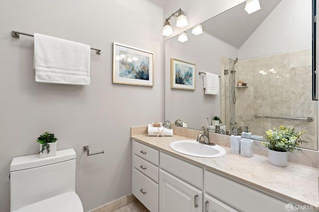 a bathroom with a sink a potted plant and a toilet