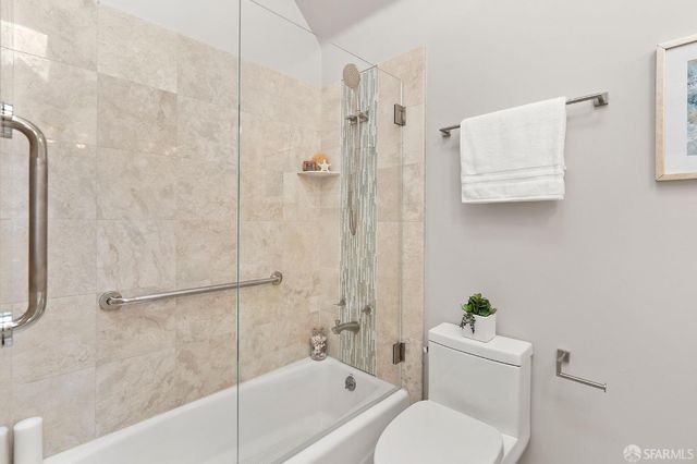 a bath room with a toilet and a bath tub