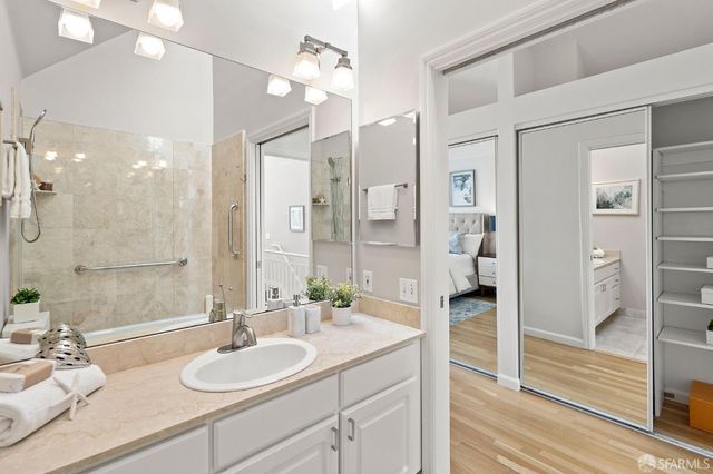 a bathroom with a sink vanity granite shower and a mirror