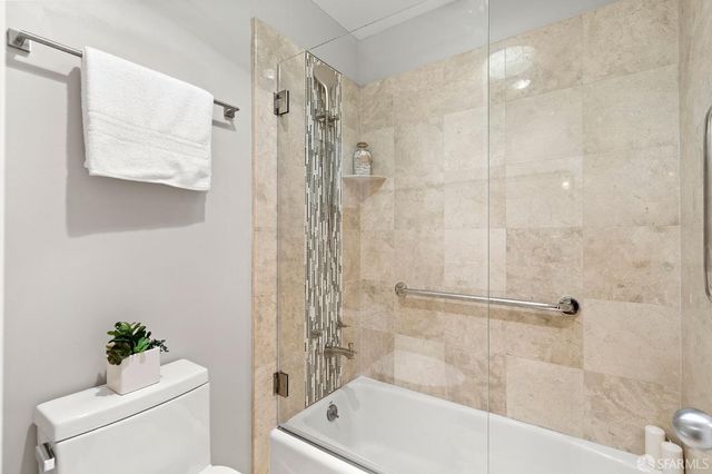 a bathroom with a shower a toilet and a shower