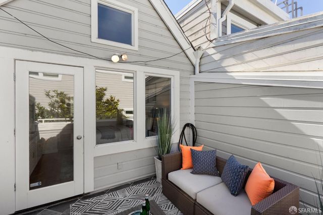 a view of a door and chair in the balcony