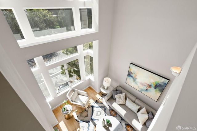 a view of living room with furniture and wooden floor
