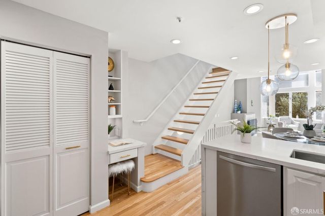 a view of entryway and hall with wooden floor
