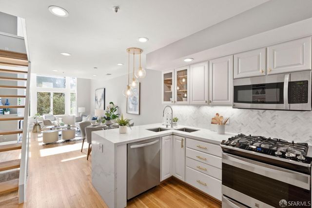 a kitchen with a sink stove and microwave