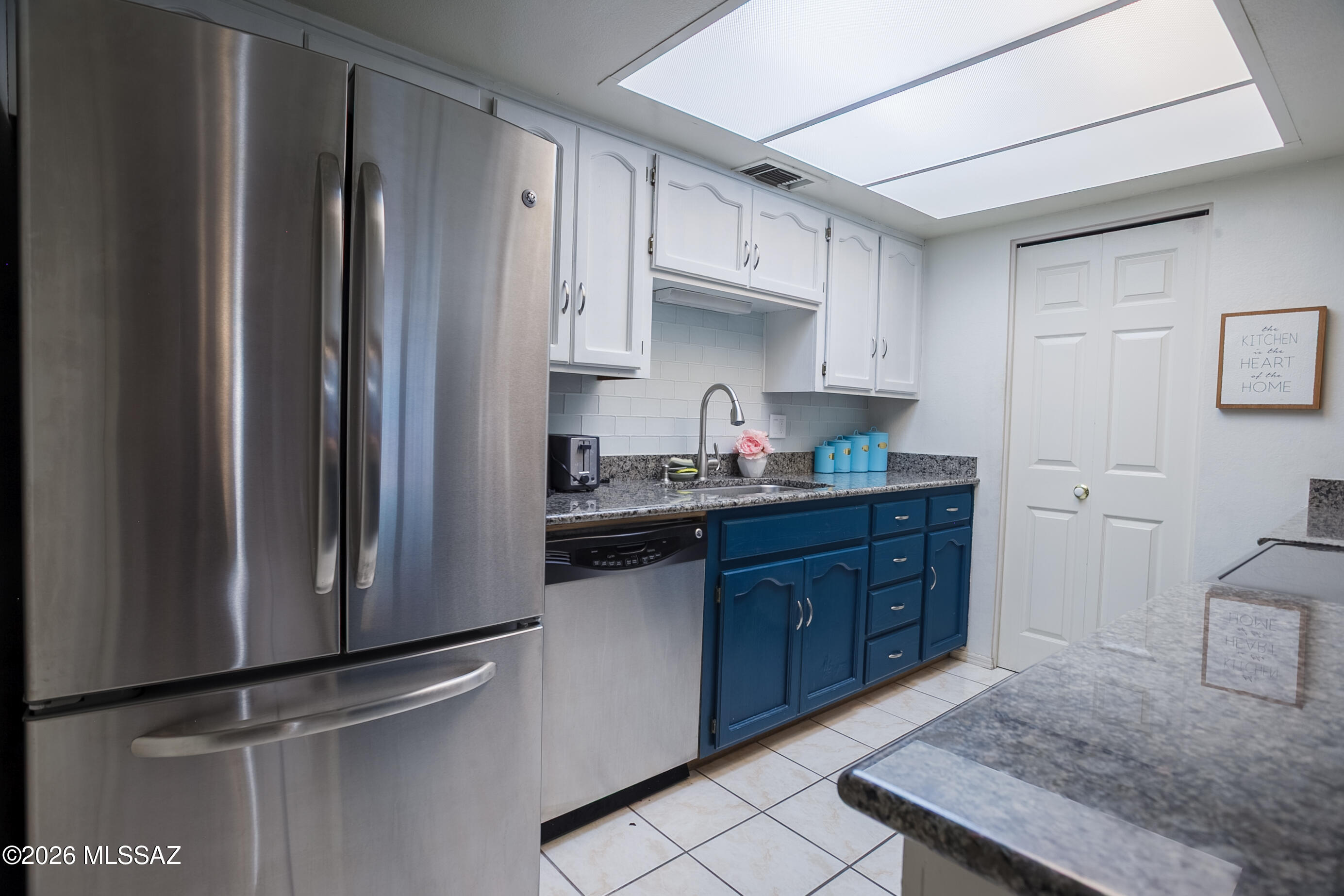 1200 East River Road, Unit B27 Tucson, AZ 85718 - Photo 15 of 40 a kitchen with stainless steel appliances granite countertop a refrigerator sink and cabinets