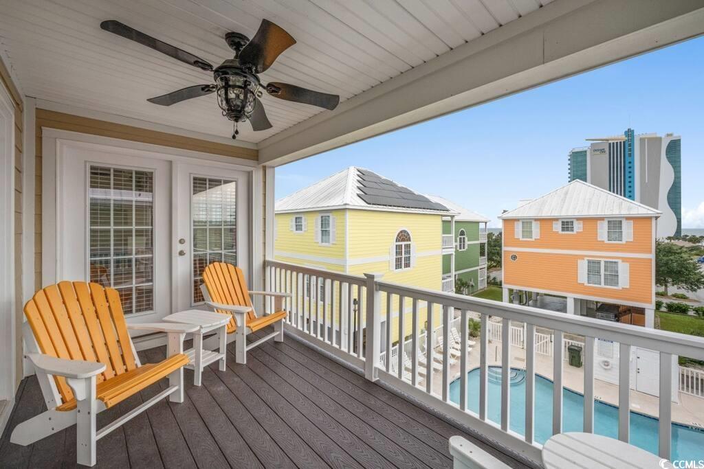520 Caribbean Way Myrtle Beach, SC 29577 - Photo 18 of 21 Balcony with view of pool area and a ceiling fan