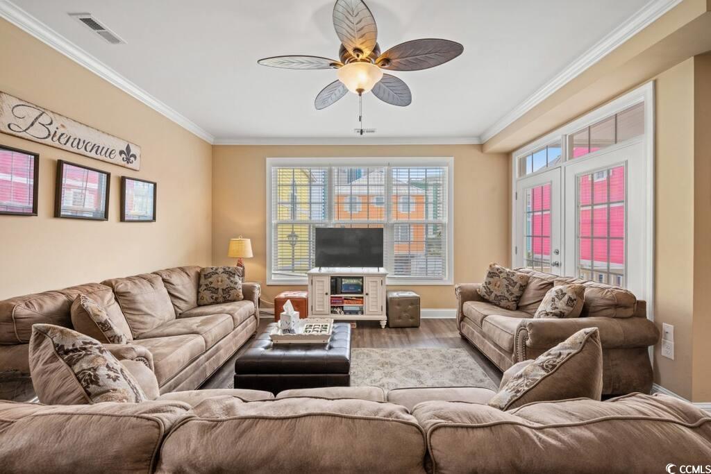 520 Caribbean Way Myrtle Beach, SC 29577 - Photo 2 of 21 Living area with ornamental molding, ceiling fan, wood finished floors, and plenty of natural light