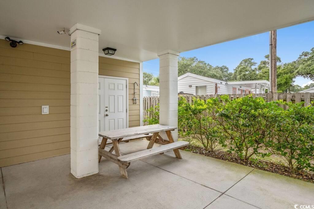 520 Caribbean Way Myrtle Beach, SC 29577 - Photo 21 of 21 Covered porch with outdoor dining area